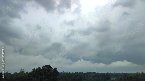 Dramatic Overcast Sky And Storm Clouds Rolling Over A Lush Green Forest Landscape