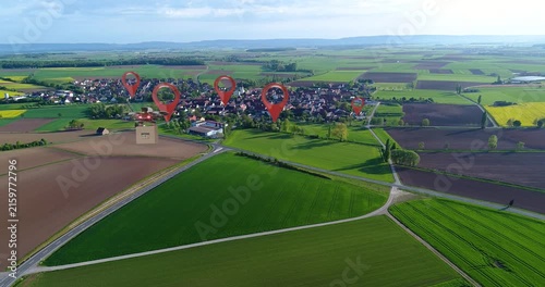 Futuristic City Concepts: A Look At The Next Generation Of Cities. An aerial cargo drone carries a cardboard box to a customer. A delivery drone flies over a city and delivers a package.