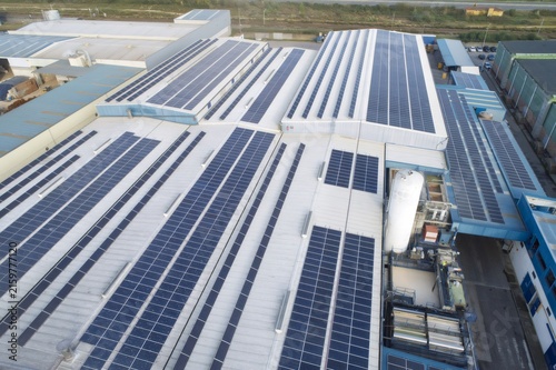Картината върху платно Industrial building roof installing numerous solar panels
