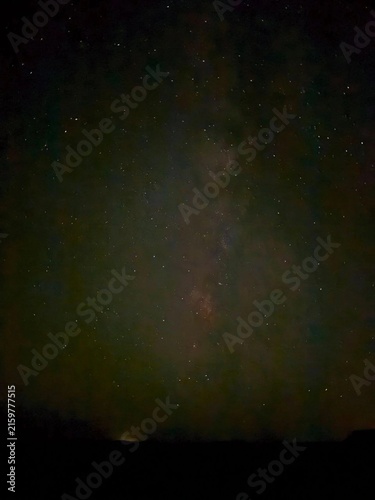 Canvas Print A dark night sky filled with countless stars and a dim Milky Way glow, creating
