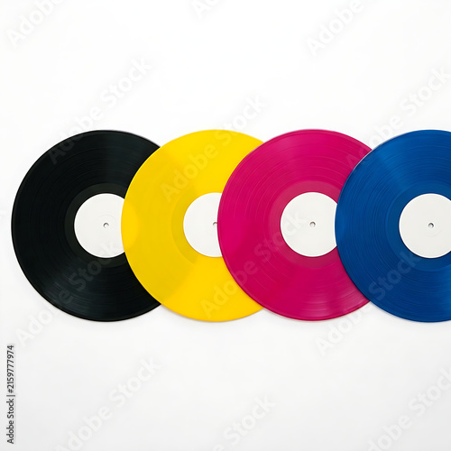 Colorful vinyl records in black yellow pink and blue overlapping on a white background for music mockups.