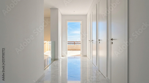 Modern Hallway with White Doors and Balcony View