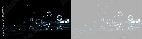 Water bubbles floating above liquid surface splash. Transparent isolated liquid element on black and checkerboard background