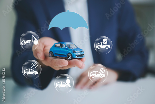 Obraz na płótnie Car insurance coverage with businessperson holding model car to represent accident protection roadside assistance vehicle repair financial security risk management and automotive support