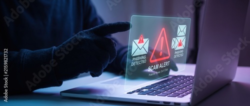 Enhancing cybersecurity awareness: a gloved hand engaging with a digital interface displaying phishing alerts and scam warnings on a laptop screen