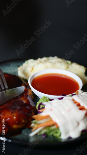 Canvastavla Cutting a Juicy Grilled Steak with BBQ Sauce, Mashed Potatoes, and Fresh Salad
