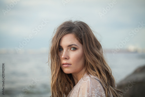 Pretty woman with brown wavy hair outdoor fashion photography