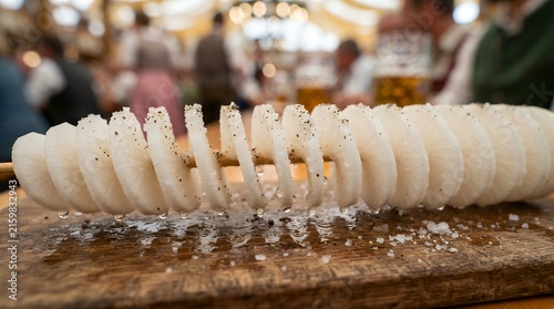 Spiral cut salted radish snack on wooden board at traditional Oktoberfest beer festival
