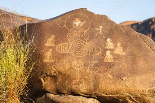 Closeup view of ancient petroglyph depicting first sermon of Buddha on rock along historic silk road, Indus valley, Chilas, Gilgit-Baltistan, Pakistan