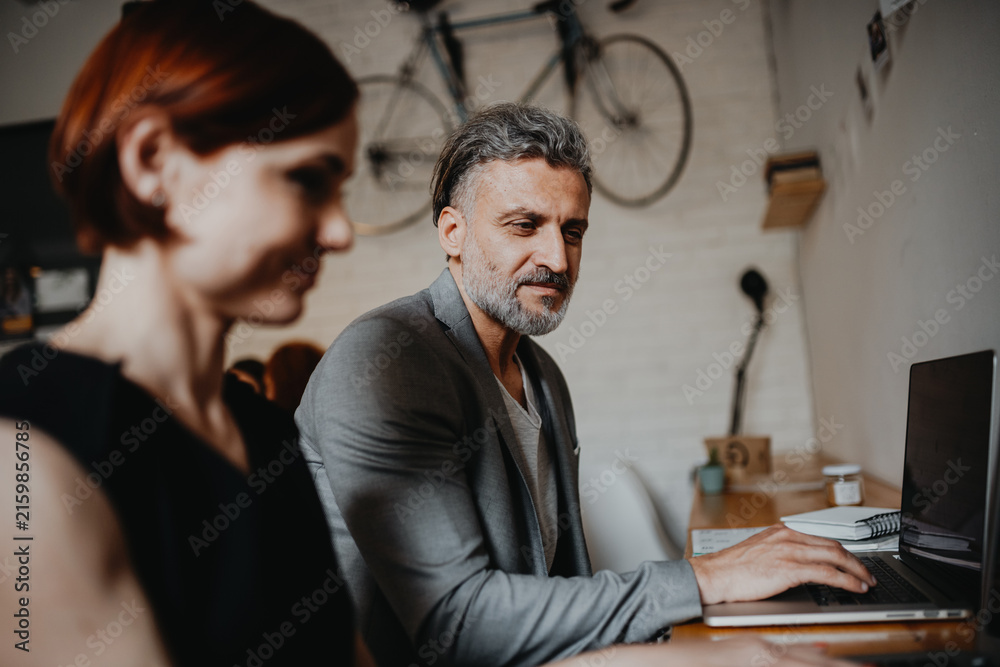 Fototapeta premium Man and woman having business meeting in a coffee shop.
