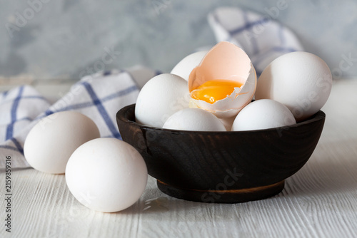 Fresh Eggs in Wooden Bowl.