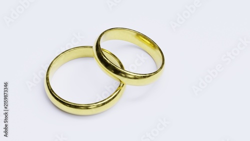 Two gold wedding rings isolated on white, symbolizing marriage, unity, romance and lasting commitment