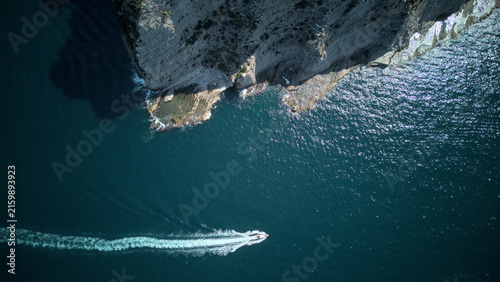 Top down aerial view of a speedboat off a sea cliff - Sorrento Coast