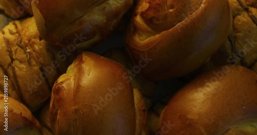 Delicious baked goods. Golden buns arranged on a plate. Sweet buns.