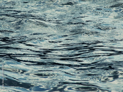Fotografie Dynamic fluid surface background showing active water eddies and ripples