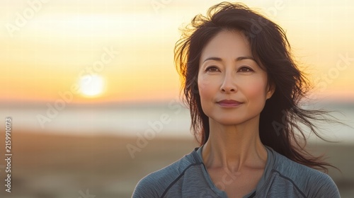 Woman contemplates sunset peaceful and serene.