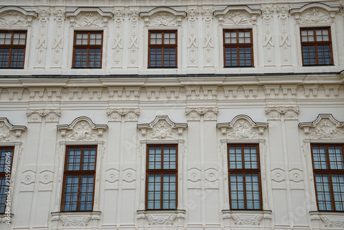 Detailed view of an elegant historic facade with ornate plasterwork and symmetrical windows in Vienna, Austria, ideal for architecture, heritage, urban design and travel themes.