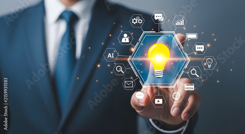 A professional businessman interacting with a digital interface featuring a glowing light bulb icon representing creative business innovation and strategy