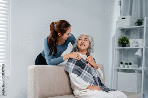 Quadro su tela Young woman provides compassionate care to elderly woman at home