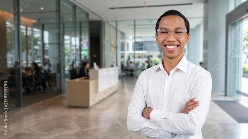 Indonesian business man investor, doubtful young male ceo executive wearing suit standing in office holding hand in chin looking away at work thinking on leadership question, feeling doubt.