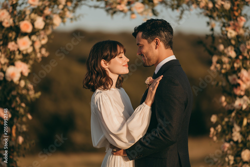 Multicultural couple sharing intimate moment during ceremony.