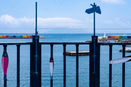 Coastal Pier Railing with Fish Cutout Ornaments Overlooking Harbor Bay