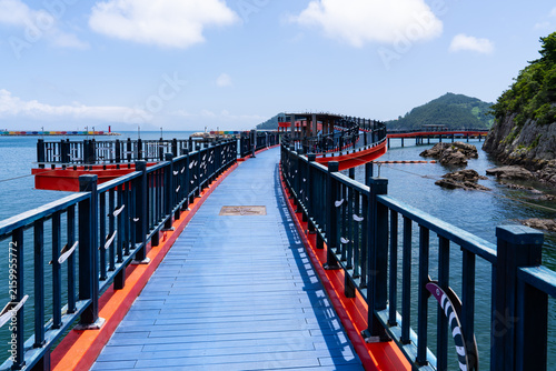 Elevated View of Winding Blue Coastal Pier Bridge with Red Edge Trim