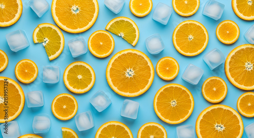 Vibrant Flat Lay Composition Featuring Fresh Citrus Orange Slices and Chilled Ice Cubes Arranged Artistically on a Bright Blue Background Backdrop