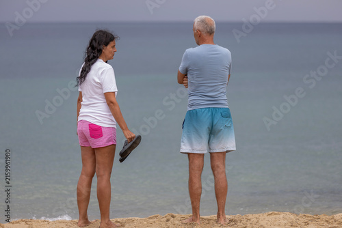 Photography Couple having serious discussion on sandy beach