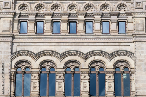 Ornate historic building facade with symmetrical arched windows and classical architectural detail. Urban heritage background for architecture, restoration, and cultural history.