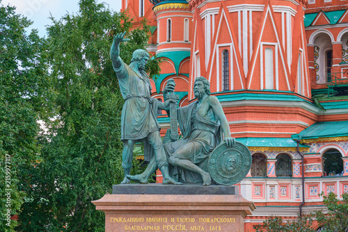 Monument to national heroes Minin and Pozharsky beside an ornate historic cathedral. Russian history, patriotism and cultural heritage in Moscow.