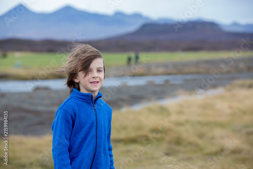 Child, playing on a road near non active vulcano in Snaefellsjokull National Park, Iceland autumntime
