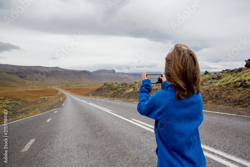 Child, playing on a road near non active vulcano in Snaefellsjokull National Park, Iceland autumntime