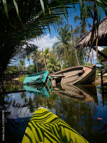 Sunken boat on a river near Kampot Cambodia, discovered while kayaking