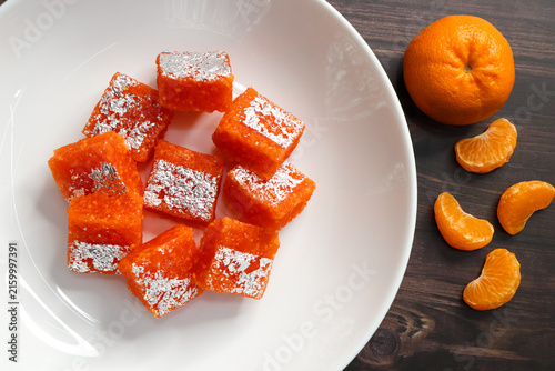 Nagpur Orange Barfi. Traditional Indian mithai made with milk solids and fresh Nagpur orange pulp. Soft, creamy fudge texture with tangy citrus flavor, inspired by India’s Orange City.