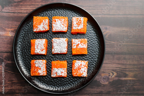 Nagpur Orange Barfi. Traditional Indian mithai made with milk solids and fresh Nagpur orange pulp. Soft, creamy fudge texture with tangy citrus flavor, inspired by India’s Orange City.