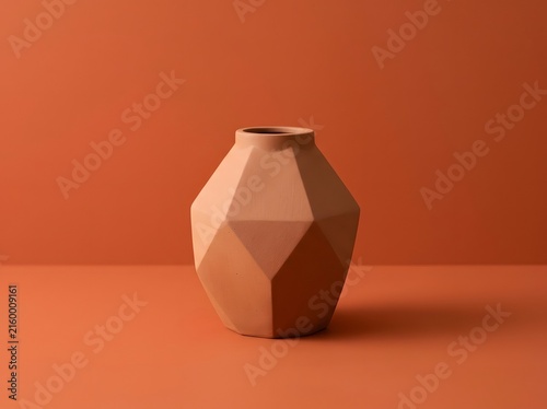 Modern Minimalist Geometric Terracotta Ceramic Vase on Solid Orange Backdrop