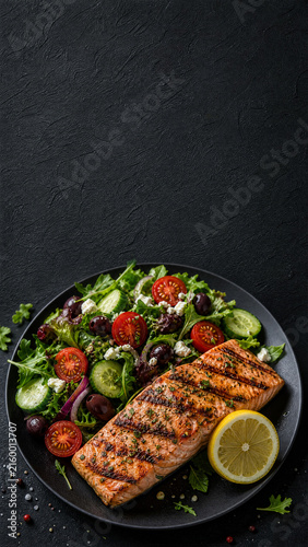 Vertical Portrait of Mediterranean Grilled Salmon and Fresh Salad with Copy Space
