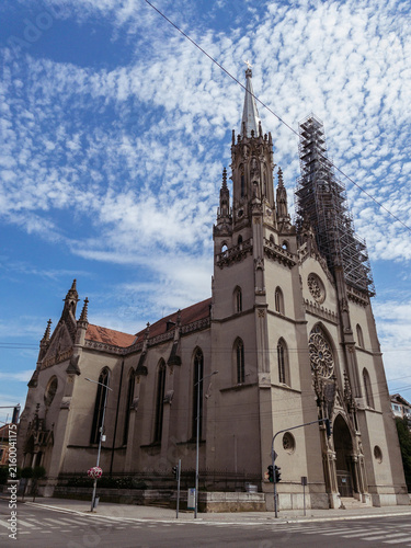 Obraz na płótnie Church, cathedral architecture, gothic exterior and tower against a bright blue
