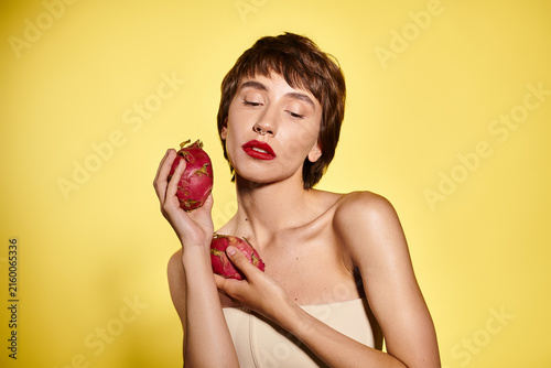 Canvastavla A young woman cherishes fresh dragon fruit while promoting healthy eating habits