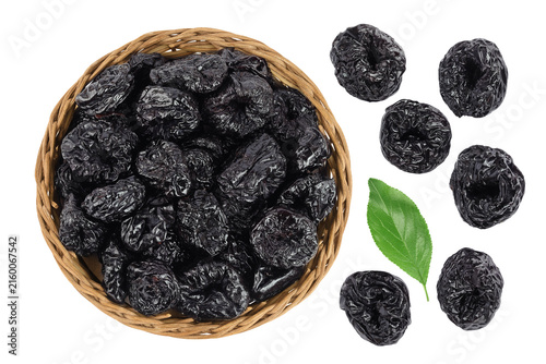 Prunes in wicker basket isolated on white background, heap of dried plums. Top view. Flat lay