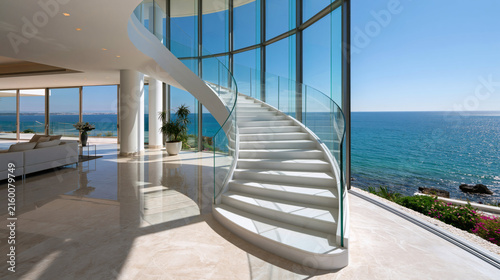 Modern Staircase Overlooking Ocean: A stunning architectural marvel, this contemporary home features a sweeping white staircase with glass railings.