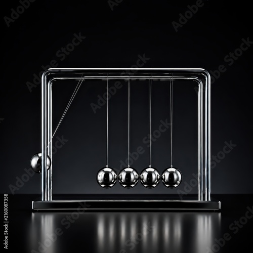 Chrome newtons cradle spheres mid swing on dark background