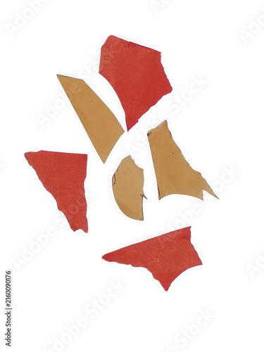 Scattered red and gold paper shards on white background