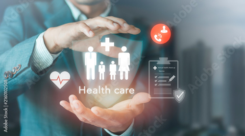 Businessman holding family health care protection concept on virtual screen. Annual medical check-up, vaccination, emergency call, insurance policy coverage, family welfare and life security.