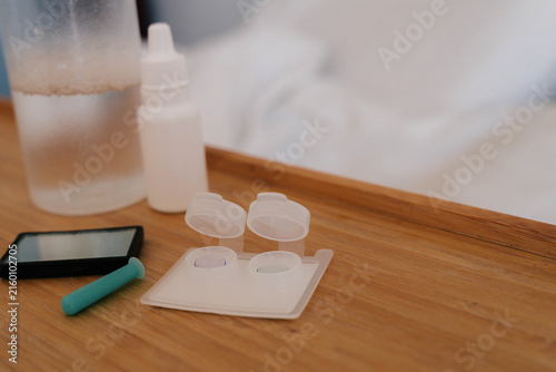 Принти на полотні Orthokeratology lens cases, contact lenses and insertion tool arranged on a wooden surface