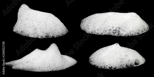 Fotografie White soap foam bubbles isolated on a black background, featuring soft frothy shapes, detailed bubble texture, glossy highlights, fluid forms, and clean abstract elements for advertising and design