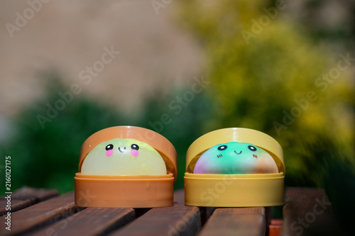Adorable dumpling squishy toys against a natural background.