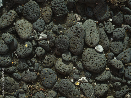Porous black volcanic stones on the ground in Iceland
