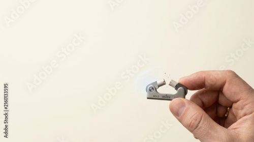 Individual holding a small object depicting strategic exit discipline through timely resource commitment awareness
